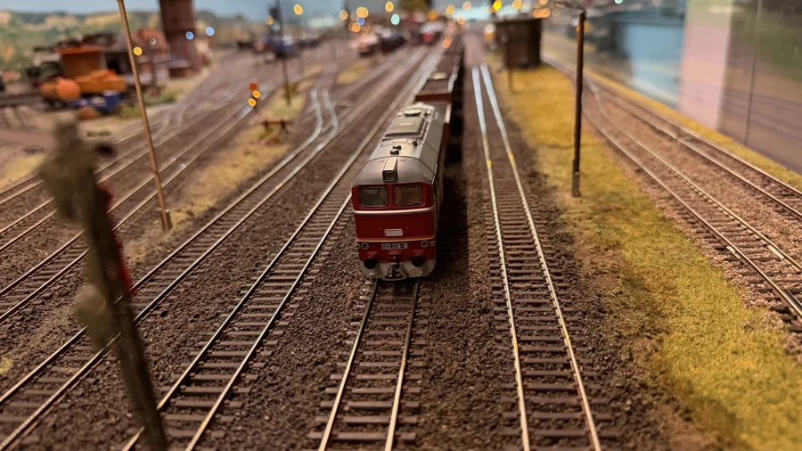 A red diesel locomotive beside the station platforms