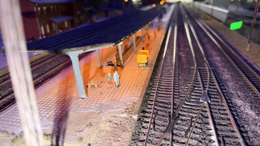 An illuminated platform beside the station tracks
