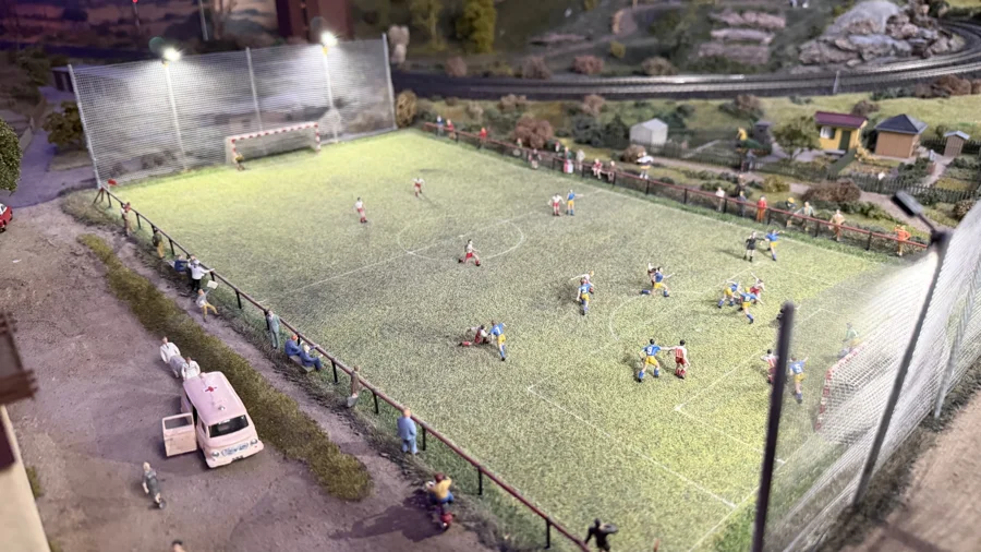 A miniature football match beside the railway