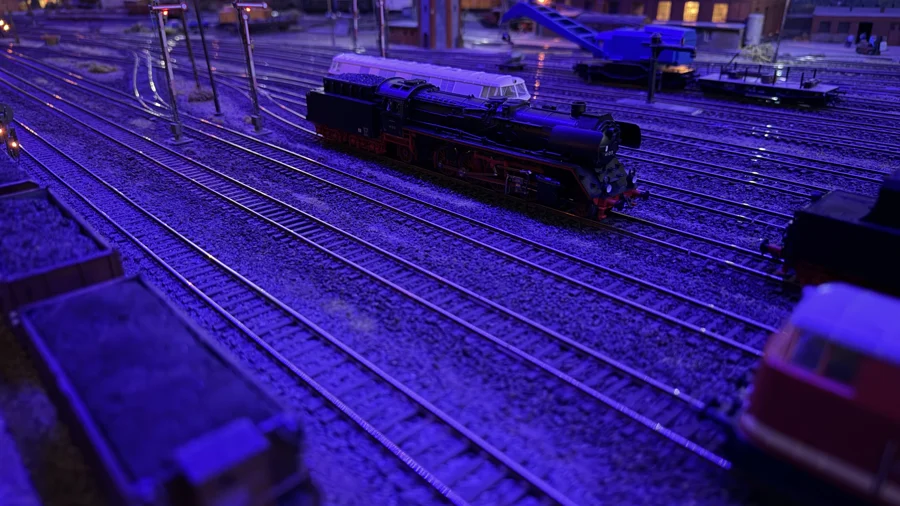 Steam locomotives beneath the evening lights