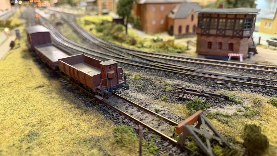 Freight wagons passing a hillside signal box